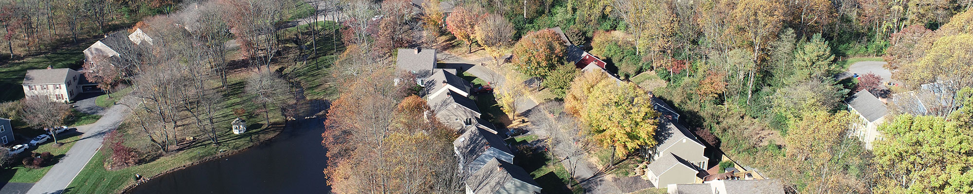 Homes clustered around a scenic pond in Deerfield Knoll, a Conservation Subdivision in Willistown Township.