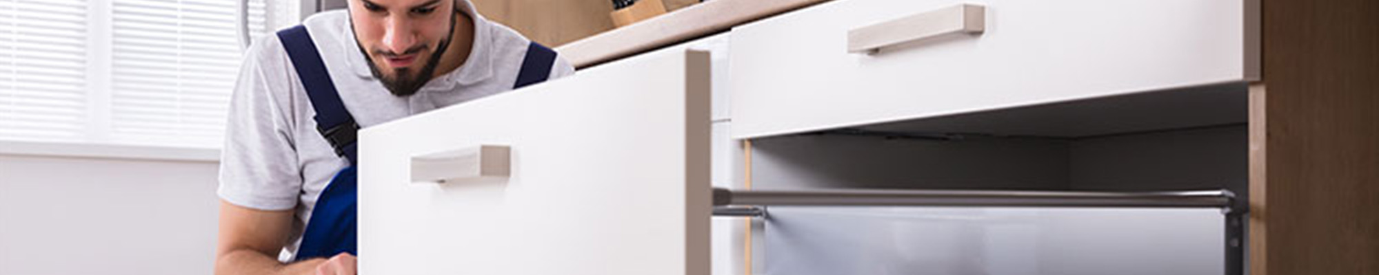 man working on a drawer