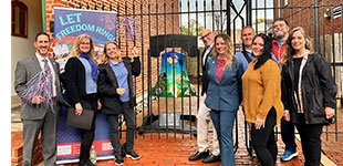 staff in front of bell
